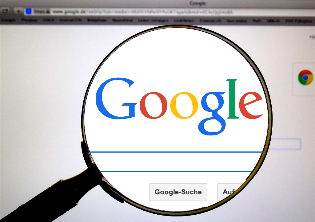 Google logo and a magnifying glass Google logo and a magnifying glass